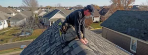 a skilled roofer carefully inspecting shingles on a roof, highlighting expertise and precision.